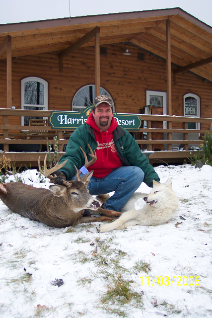 Chris Markovich with his Whitetail Deer & his almost white Timber Wolf. : Both the Buck & the Wolf were harvested at Harris Hill Resort.